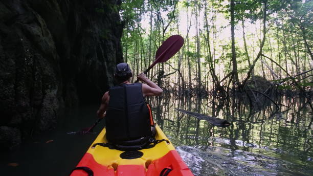 istock Man passes route for advanced kayakers paddling near cliff 2158200473