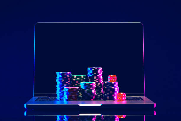 istock Laptop With Stacks of Poker Chips on Green Felt 2158200997