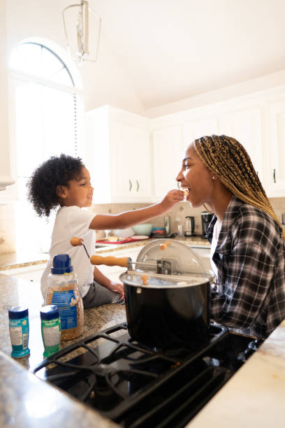 istock Child feeding mom some food 2158201100