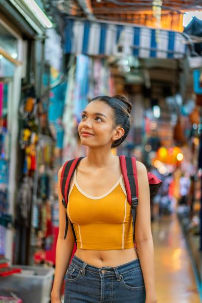 istock Happy Female Tourist Exploring Vibrant Weekend Market with Backpack 2158201109