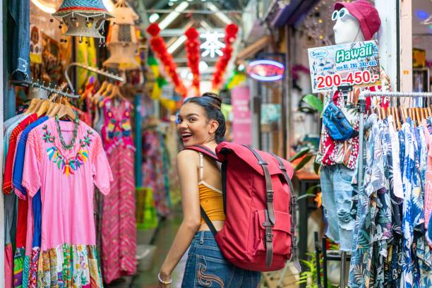 istock Happy Female Tourist Exploring Vibrant Weekend Market with Backpack 2158201222