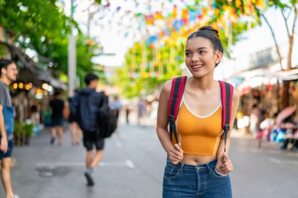 istock Happy Female Tourist Exploring Vibrant Weekend Market with Backpack 2158201276