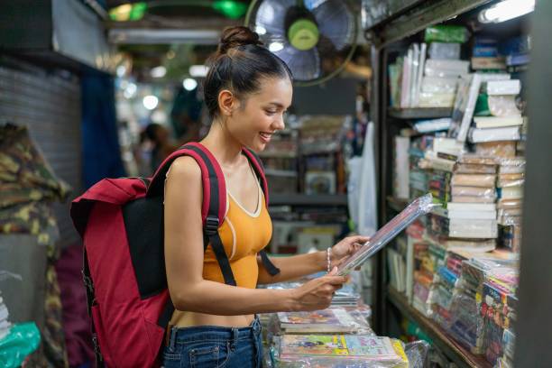 istock Happy Female Tourist Exploring Vibrant Weekend Market with Backpack 2158201360