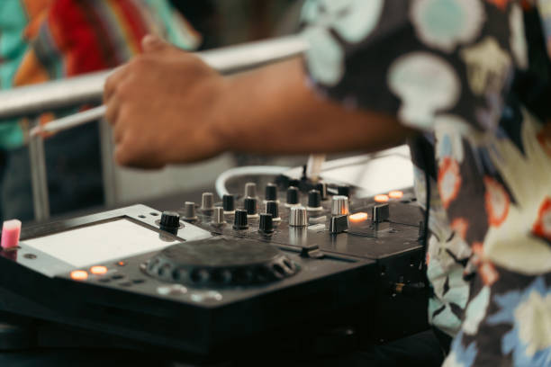 istock Dj smoking a cigarette while playing with the mixer at an outdoor party 2158201525