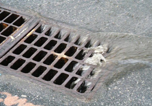 istock close up on rain water flowing into manhole on the street 2158202821