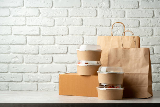 istock Take out food in boxes and craft bag against brick background 2158202975