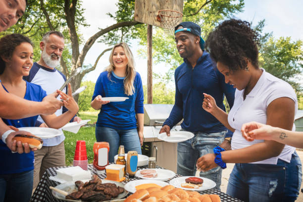 istock Friends drinking and eating at a tailgate party 2158204014