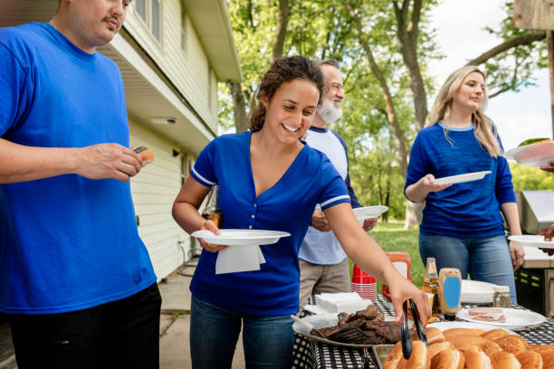 istock Friends drinking and eating at a tailgate party 2158204019