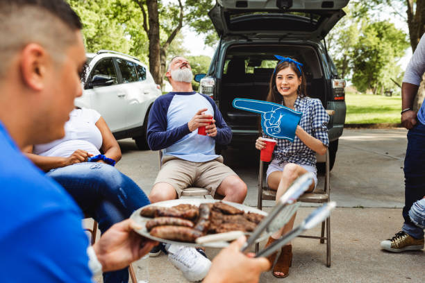 istock Man handing out burgers at a tailgate party 2158204021