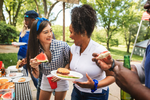 istock Friends celebrating and eating at a tailgate party 2158204086