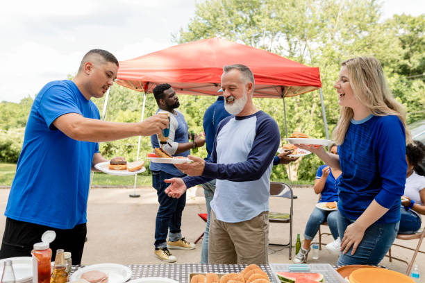 istock Friends drinking and eating at a tailgate party 2158204100