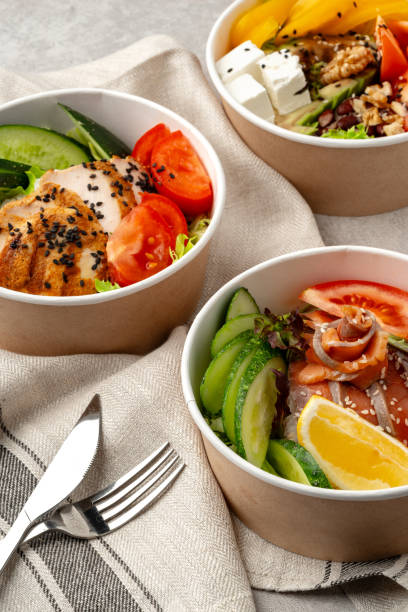 istock Beautiful composition with poke bowls on gray background with napkin 2158204135