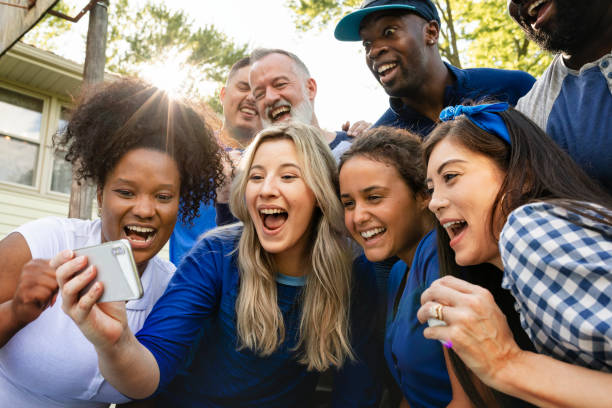 istock Supporters watching their team win the game on a mobile phone 2158204181