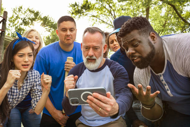 istock Baseball supporters watching their team lose the game on a phone 2158204299