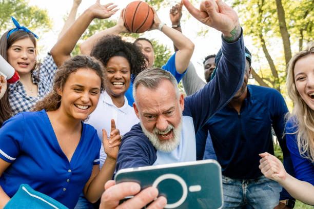 istock Basketball supporters watching their team win the game on a mobile phone 2158204336
