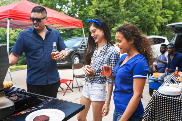 istock Friend grilling burgers at a tailgate party 2158204402
