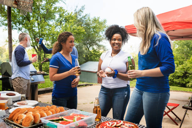 istock Friends celebrating and eating at a tailgate party 2158204518