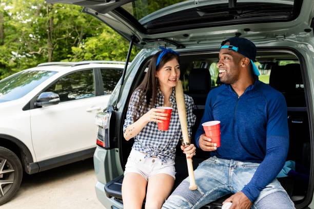 istock Baseball fans sitting in car boot at a tailgate party 2158204564