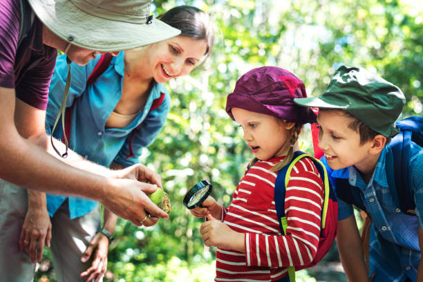 istock Father teaching his daughter how to use a magnifying glass 2158204651