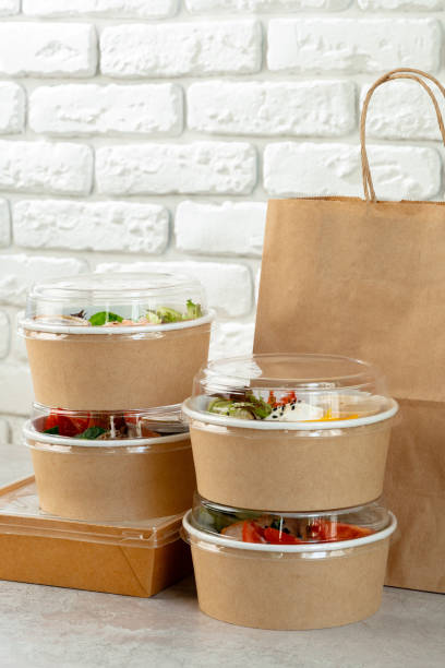 istock Take out food in boxes and craft bag against brick background 2158204652