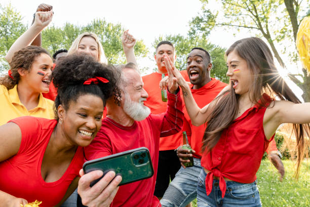 istock Supporters watching their team win the game on a mobile phone 2158204678