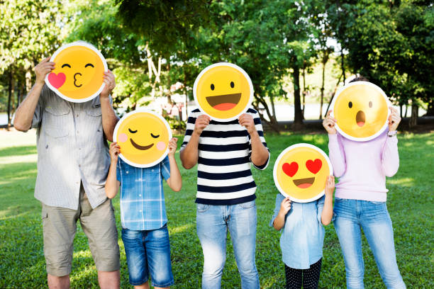 istock Happy family holding up emojis 2158204918