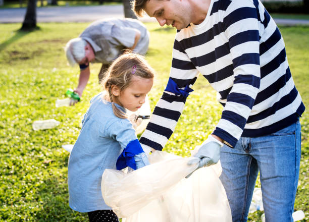 istock Kids picking up trash in the park 2158204987
