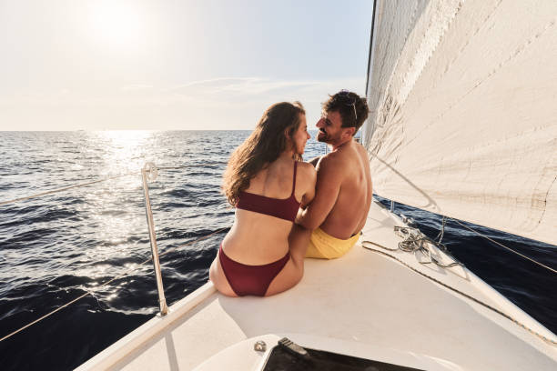 istock Happy couple talking while traveling on a yacht. 2158205795