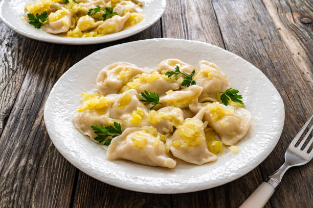 istock Russian potato dumplings with fried onion on white plate on wooden table 2158205869