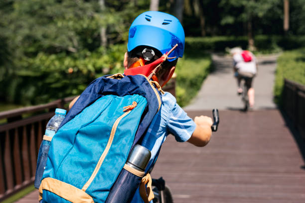 istock Boy riding a bike in the park 2158205943