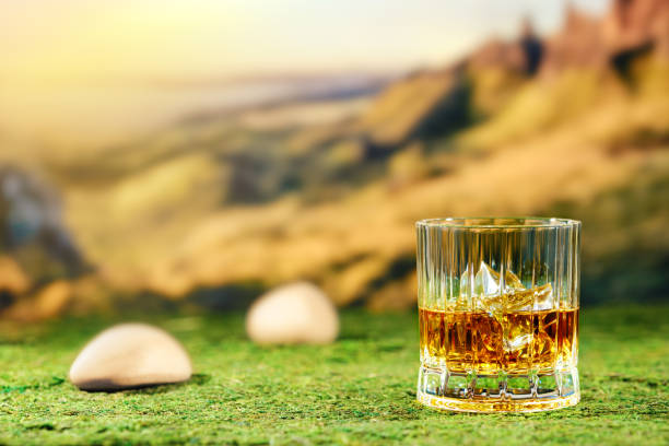 istock Glass of peat whiskey on green moss 2158206440