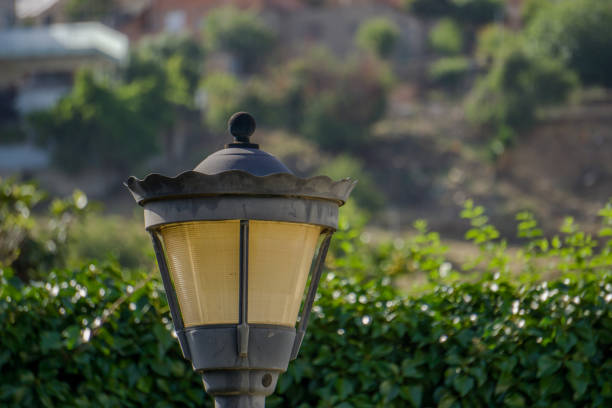 old street lamp with unfocused green background