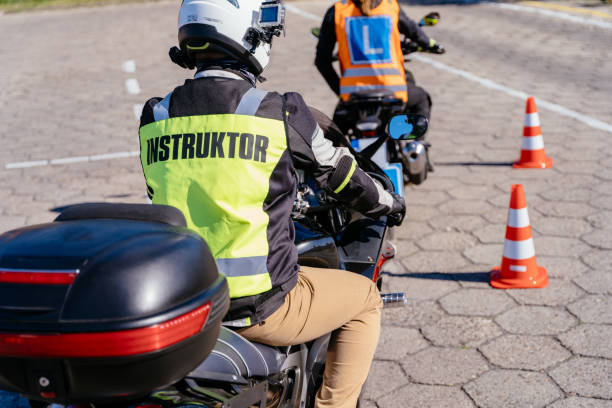 istock A man in a yellow jacket with the word instructor on it is riding a motorcycle 2158206767
