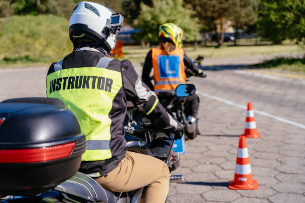 istock A man in a yellow jacket with the word instructor on it sits on a motorcycle 2158206768