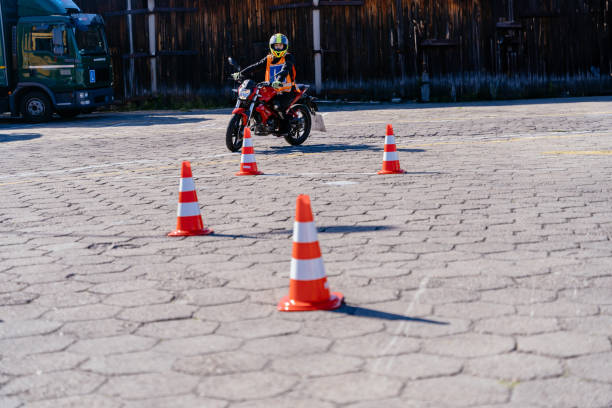 istock motorcycle driving school. a woman learns to drive before obtaining a driving license. 2158206783