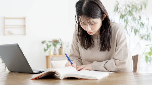 istock A woman studying for a qualification at home 2158207012