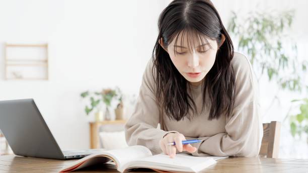 istock A woman studying for a qualification at home 2158207013