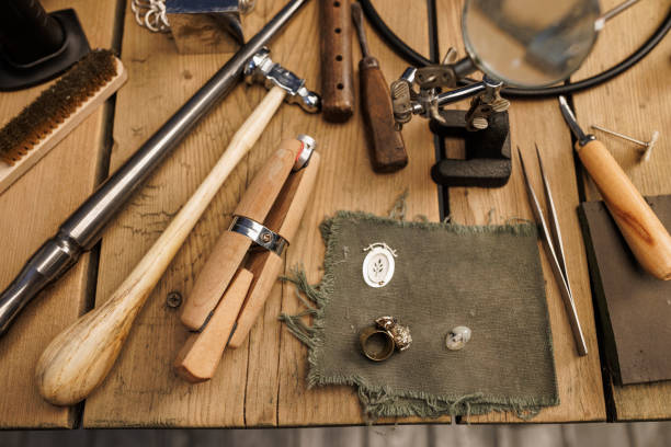 istock Jeweler workshop   Vintage and modern jeweler tools on rustic wooden table 2158207018