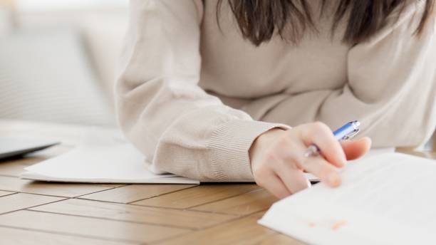 istock A woman studying for a qualification at home 2158207022