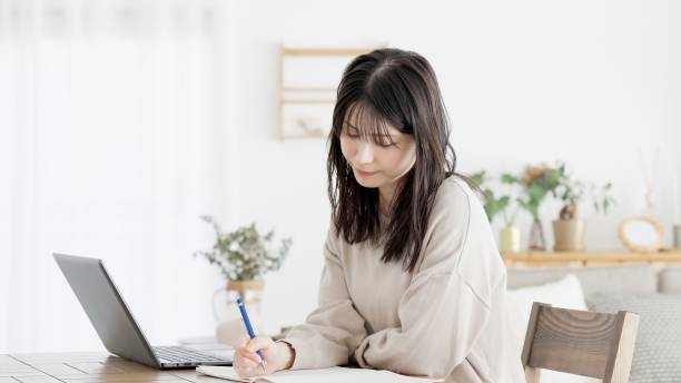istock A woman studying for a qualification at home 2158207030