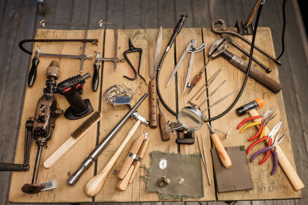 istock Jeweler workshop   Vintage and modern jeweler tools on rustic wooden table 2158207061