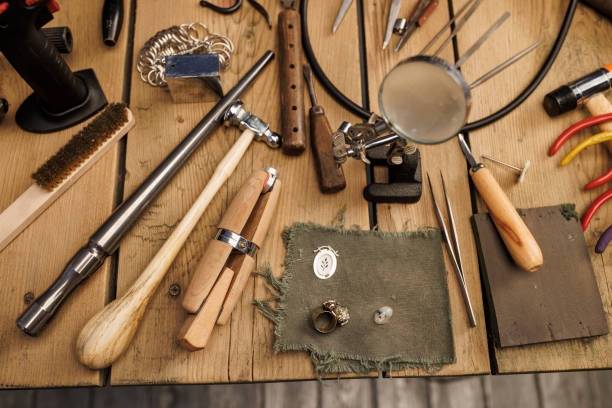 istock Jeweler workshop   Vintage and modern jeweler tools on rustic wooden table 2158207097