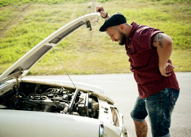 istock Men Checking Broke Down Car on Street Side with Open Hood 2158208146