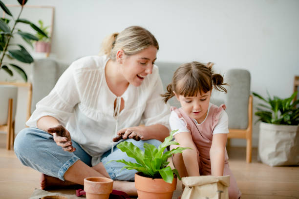 istock Kid DIY plant potting with mom at home 2158208371