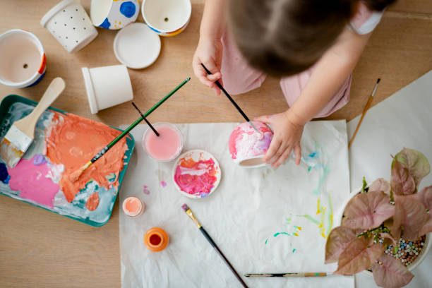 istock Kid painting plant pot DIY hobby 2158208606