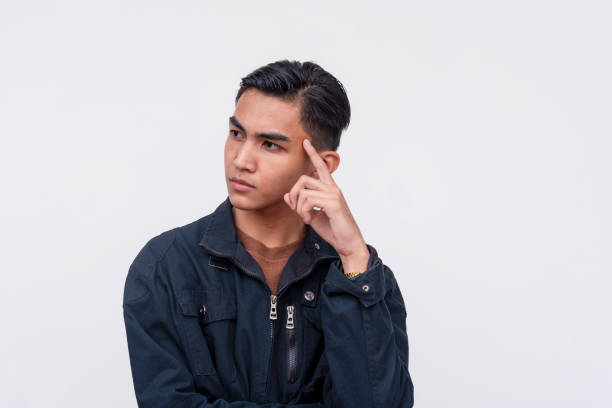 istock A young asian man thinking about ideas. Brainstorming for new concepts. Looking serious and focused. Isolated on a white background. 2158212407