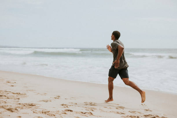 istock Black man running on the beach 2158212547