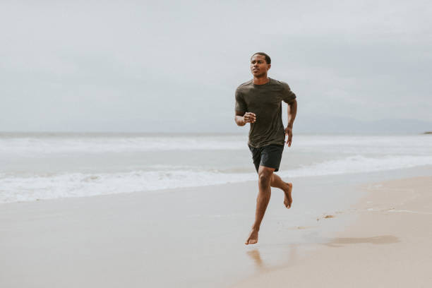 istock Black man running on the beach 2158212573