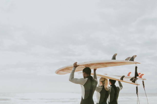 istock Happy friends surfing at the beach 2158212595