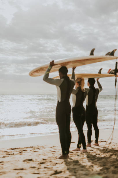 istock Happy friends surfing at the beach 2158212610